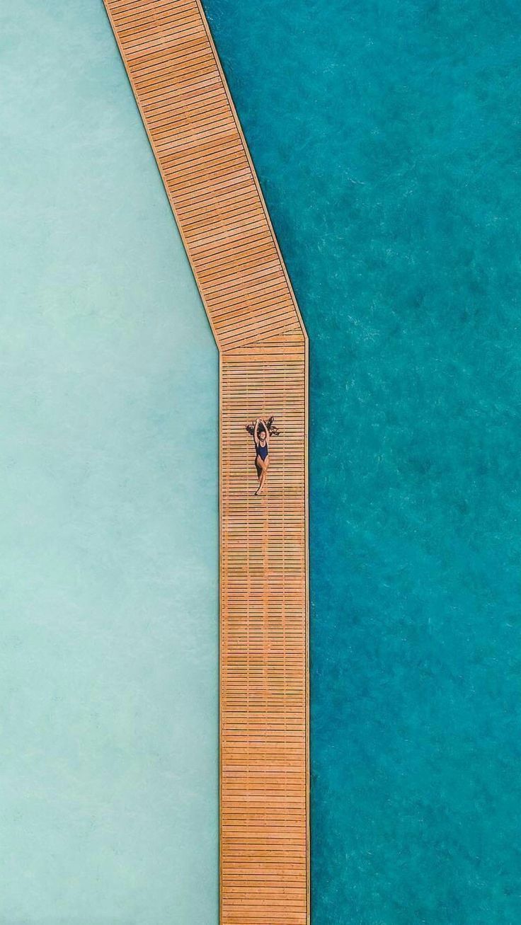 Drone Photography Inspiration | Woman lying on a tropical dock
