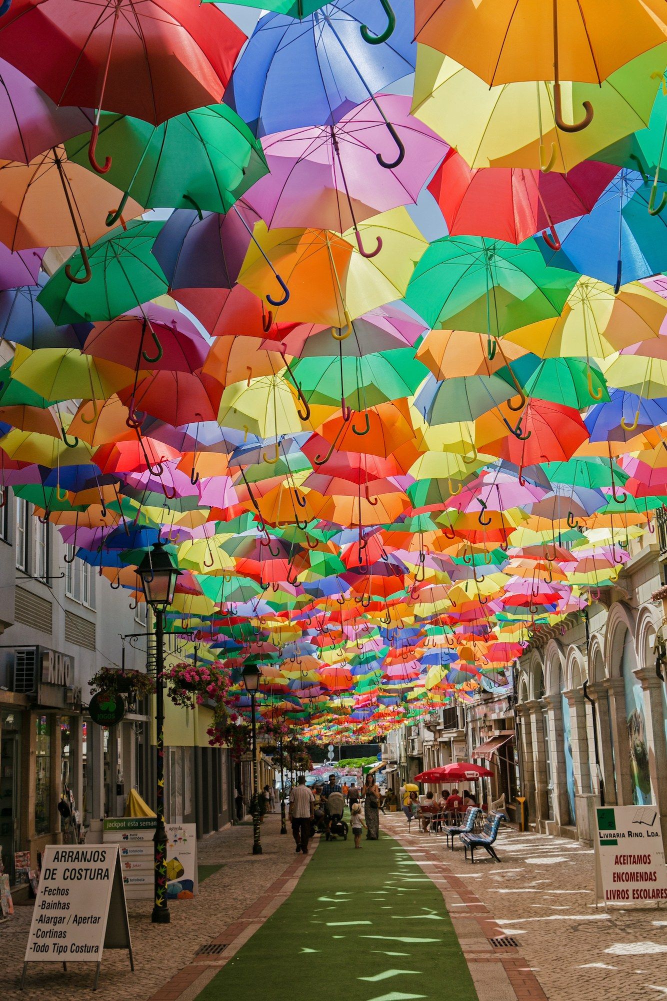 Inspo from our friends! Águeda's Umbrella Sky Project began in 2011 as a part of the Portuguese city's annual Ágitagueda Art Festival. Each summer, when temperatures soar, a handful of Águeda's narrow streets feature canopies of colorful umbrellas that provide shade to the pedestrians bel