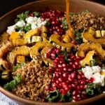 This Autumn Harvest Salad uses the beautiful produce available as the months start to get colder, such as delicata squash, kale, and pomegranates, as well as farro and goat cheese to make a hearty cold weather salad. Then it is all tossed together with a maple apple cider vinaigrette! #ad