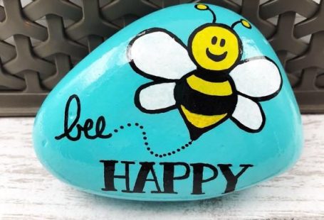 Spread happiness and encouragement! This cute hand-painted rock says Bee Happy and features a yellow and black bumblebee. The background is sky blue. It measures around 3.5 inches in length (size and shape will vary from stone to stone). This stone is painted with acrylics and sealed