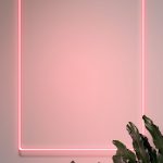 Neon red hello with a flamingo in a frame