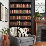 This beautiful mantel is original to the house, and we refinished it and moved it to be a part of the library wall. The family wanted to include a TV in their living room to make it functional for them, but we were afraid it would have looked really out of place on the library wall. The solution was actually the two beautiful mirrors above the mantel. They open up on a piano hinge to easily hide the TV when it’s not in use.