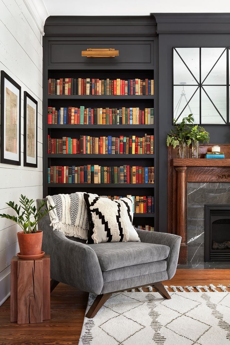 This beautiful mantel is original to the house, and we refinished it and moved it to be a part of the library wall. The family wanted to include a TV in their living room to make it functional for them, but we were afraid it would have looked really out of place on the library wall. The solution was actually the two beautiful mirrors above the mantel. They open up on a piano hinge to easily hide the TV when it’s not in use.