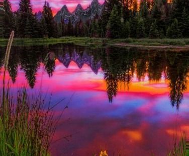 Late spring sunset by the iconic beaver dam at Schwabachers Landing in Jackson Hole, Wyoming (USA)