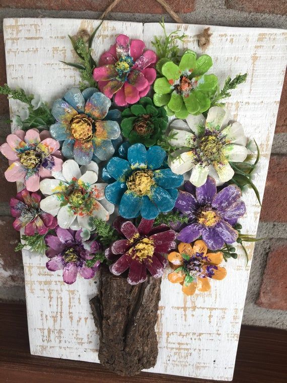 This fancy design includes pinecone flowers which are hand cut, carefully shaped and painted to resemble an authentic flower. On the wooden background, there are 13 pinecone flowers of various sizes. -Impregnation applied on the design against decay and any kind of insect formation.  Dimentions: