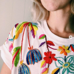 Artist Tessa Perlow likes to embroider sticky flowers with a striking and exciting placement. #textileart #fiberart #textiledesign #surfacedesign