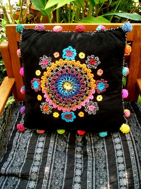 crocheted embellishments on cushion cover - pom-poms too!