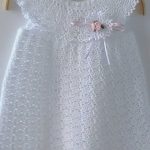 Dreamlike and romantic christening gown crocheted by hand from pure fine cotton. On the dress is a beautiful Boutonnière (crocheted plug-in flower) attached. It is attached to a transparent push button, which can be easily removed, for example, before washing. The dress fits wonderfully on special
