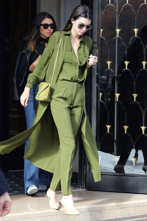 Leaving her hotel in Paris, Kendall goes monochrome in an olive green ensemble by Elie Saab with a matching bag and neutral pumps.