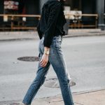 distressed denim with black top and chanel shoes