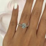 Oval shaped diamond. Side stone pave setting in 14k white gold. Ovals are a cool and beautiful shape for a bride to be