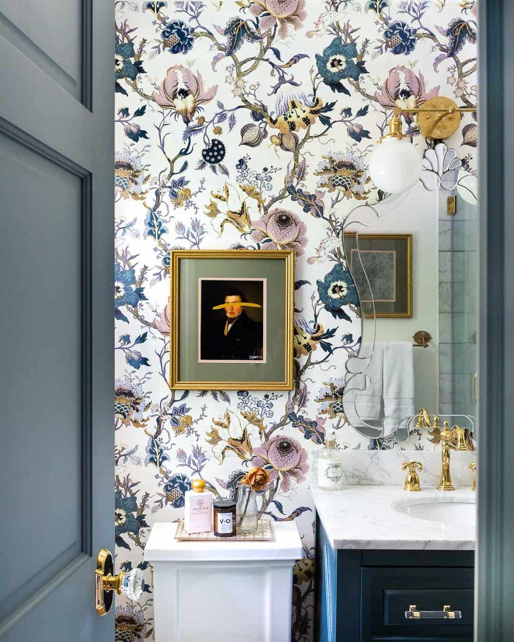The door, trim and vanity in this stunning bathroom have been painted in complementary blue shades found in the House Of Hackney wallpaper. Image credit:    A Glass Of Bovino