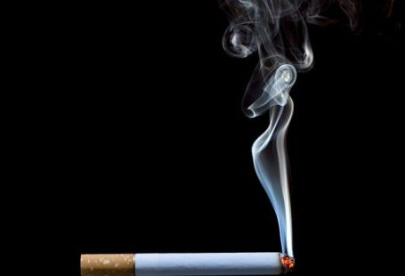 Premium Photo | Smoking cigarette on black background
