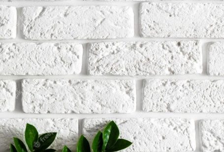 Premium Photo | Green plant branch on white brick wall modern home interior  background, natural leaves on clean texture concrete cement pattern surface brickwork, vertical image with copy space for text