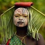 Ethiopian tribe who wear face paint and don floral headpieces