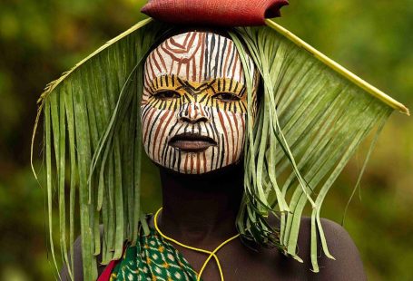 Ethiopian tribe who wear face paint and don floral headpieces
