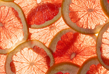 "Pomelo Or Grapefruit Slice Background" by Stocksy Contributor "Juno"